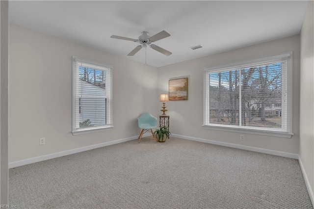 spare room with carpet flooring, plenty of natural light, and ceiling fan