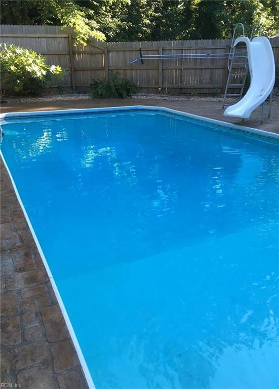 view of pool with a water slide