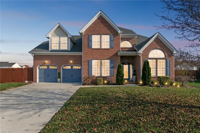 front of property featuring a garage and a yard