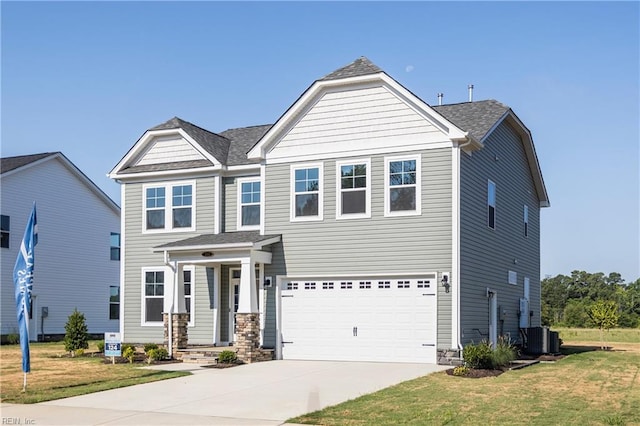 view of front facade featuring a garage, a front yard, and central AC