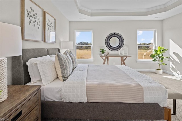 carpeted bedroom with a raised ceiling, crown molding, and multiple windows