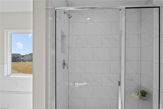 bathroom featuring walk in shower and a wealth of natural light