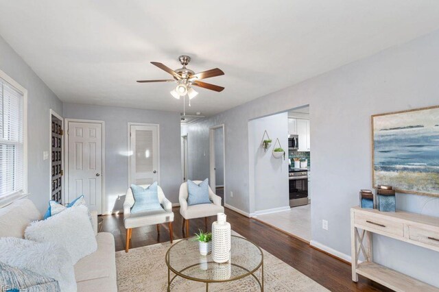 living room featuring dark hardwood / wood-style floors and ceiling fan