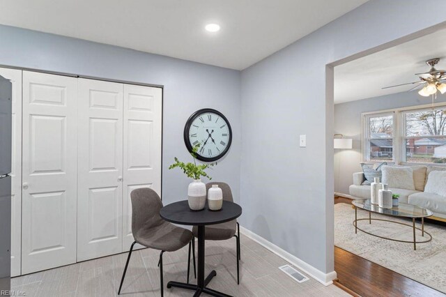 home office featuring ceiling fan and light hardwood / wood-style floors