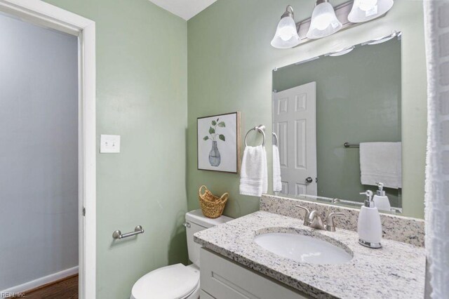 bathroom featuring vanity, toilet, and wood-type flooring