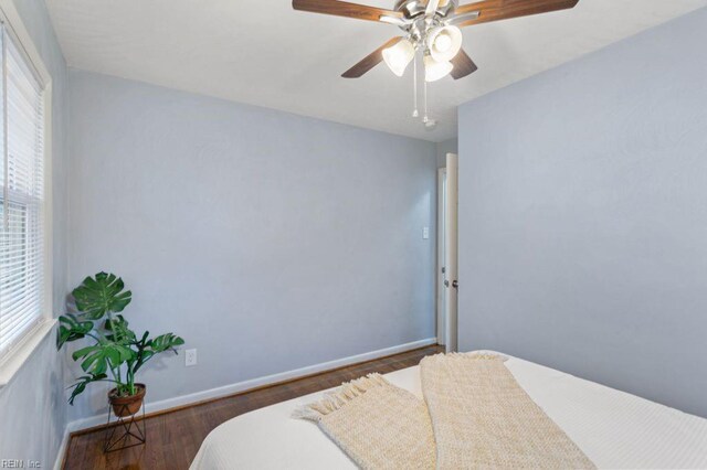 bedroom with ceiling fan and dark hardwood / wood-style flooring