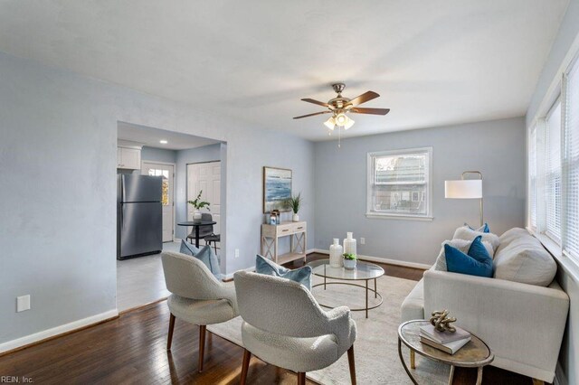 living room with hardwood / wood-style flooring and ceiling fan