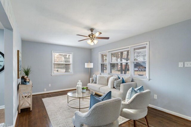 living room with ceiling fan and dark wood-type flooring