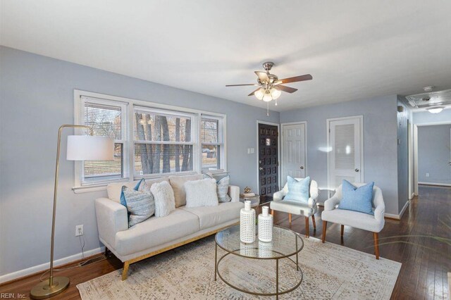 living room with ceiling fan and dark wood-type flooring