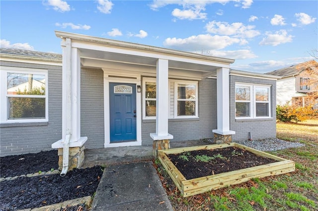 view of exterior entry with a porch