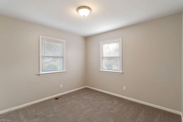 unfurnished room featuring carpet