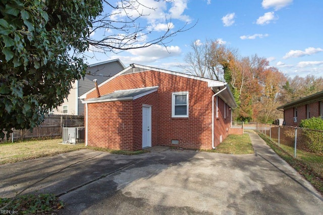 view of side of home with central AC