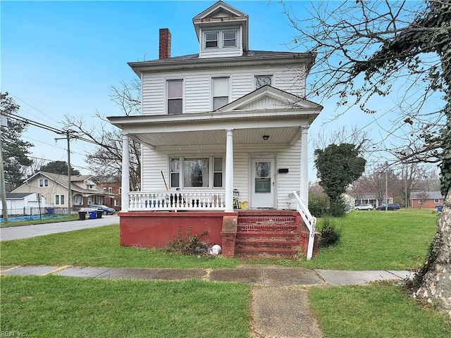 view of front facade with a front yard and a porch