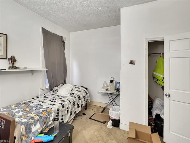 carpeted bedroom featuring a textured ceiling and a closet