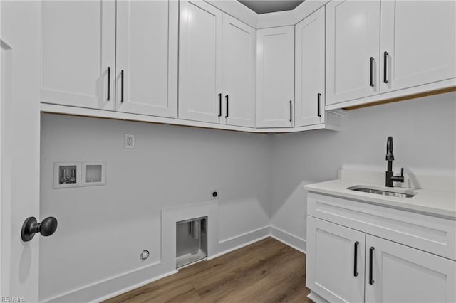 laundry area with sink, cabinets, hookup for an electric dryer, hookup for a washing machine, and hardwood / wood-style flooring