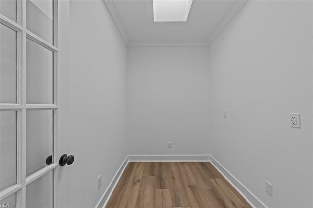 spare room with wood-type flooring and ornamental molding