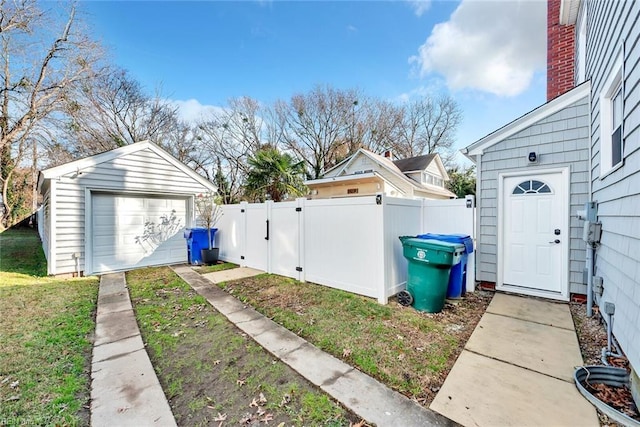 view of side of property featuring a yard, a garage, and an outdoor structure