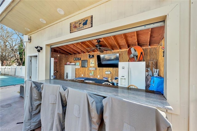 exterior space featuring ceiling fan and an outdoor bar