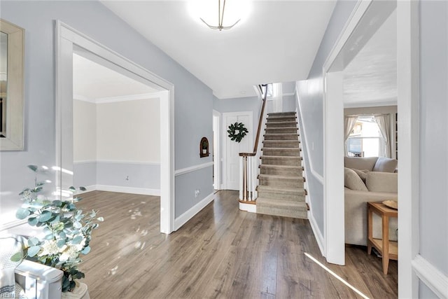 foyer entrance featuring hardwood / wood-style floors and ornamental molding