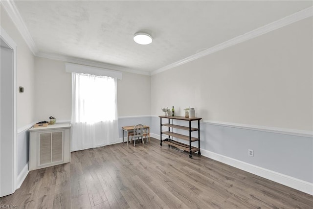 interior space with crown molding and light hardwood / wood-style flooring