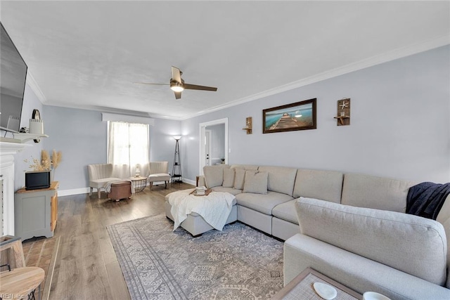 living room featuring ceiling fan, wood-type flooring, and ornamental molding