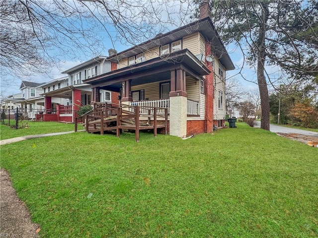 view of front of property featuring covered porch and a front yard