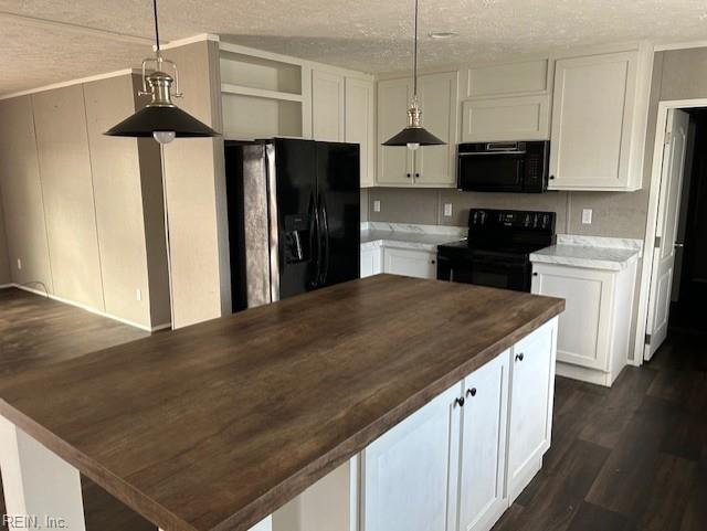 kitchen featuring dark hardwood / wood-style flooring, a textured ceiling, decorative light fixtures, white cabinets, and black appliances