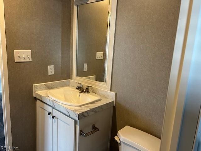 bathroom with vanity and toilet