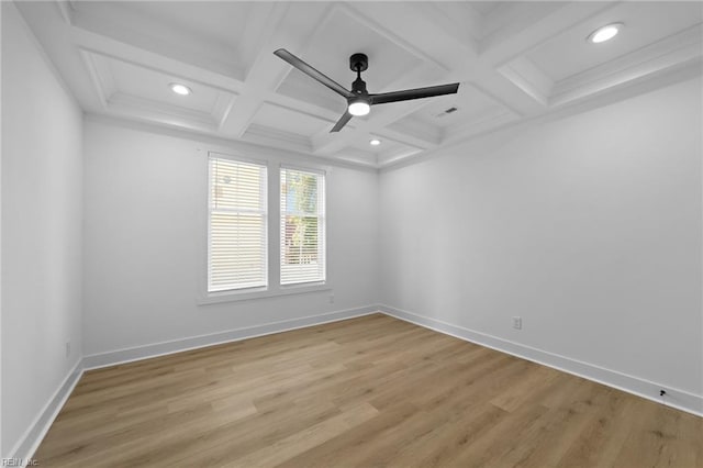 spare room featuring ceiling fan, light hardwood / wood-style floors, beam ceiling, and coffered ceiling