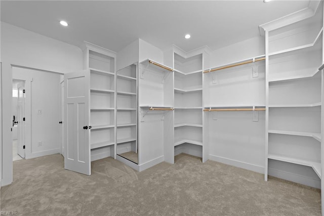 spacious closet featuring light carpet