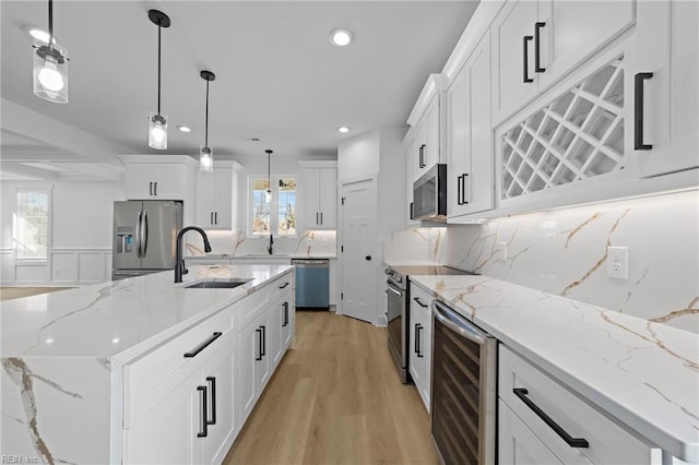 kitchen with wine cooler, sink, plenty of natural light, and appliances with stainless steel finishes