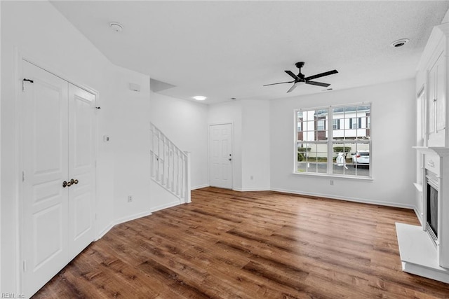 unfurnished living room with hardwood / wood-style floors and ceiling fan