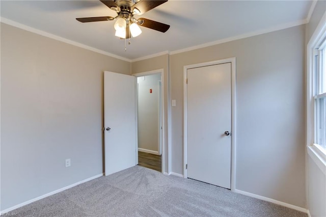 unfurnished bedroom featuring ceiling fan, light colored carpet, and ornamental molding