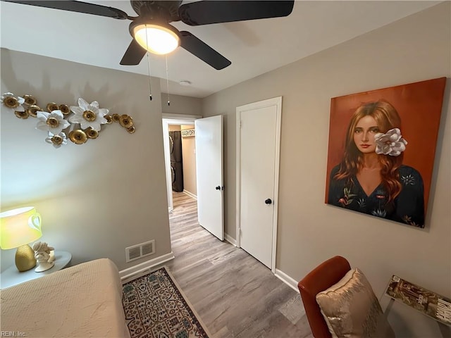 bedroom with ceiling fan and light hardwood / wood-style flooring