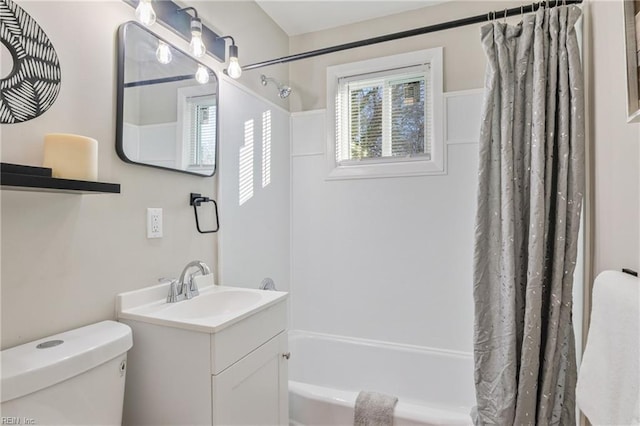 full bathroom featuring toilet, vanity, and shower / bathtub combination with curtain