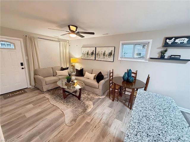 living room with ceiling fan and hardwood / wood-style flooring