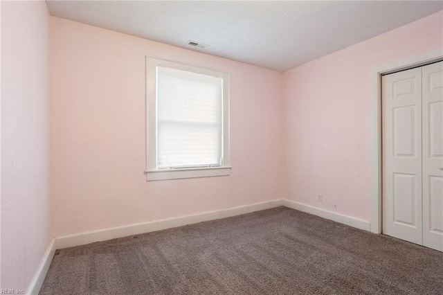 unfurnished bedroom with a closet and carpet flooring