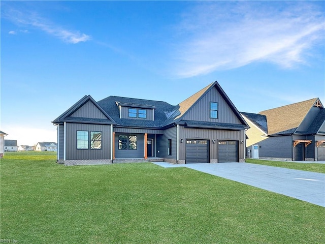 modern farmhouse style home featuring a front yard and a garage