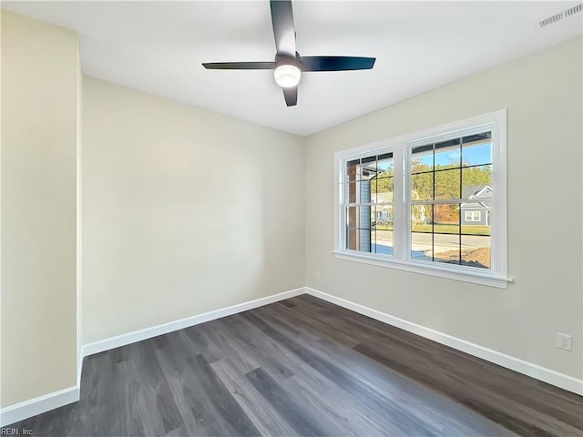 spare room with ceiling fan and dark hardwood / wood-style flooring