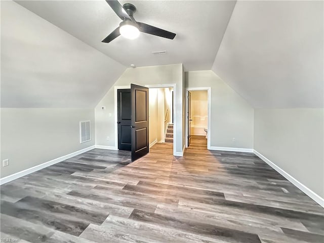 additional living space with dark hardwood / wood-style floors, ceiling fan, and lofted ceiling