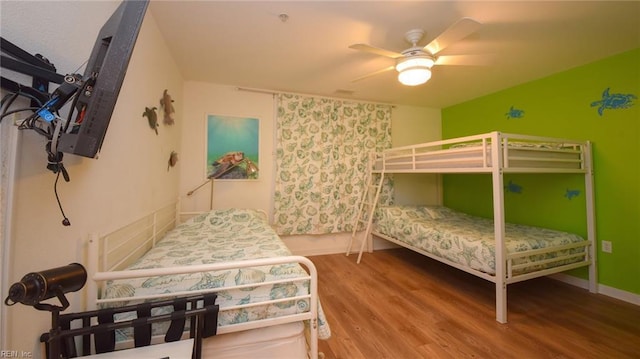 bedroom with ceiling fan and wood-type flooring