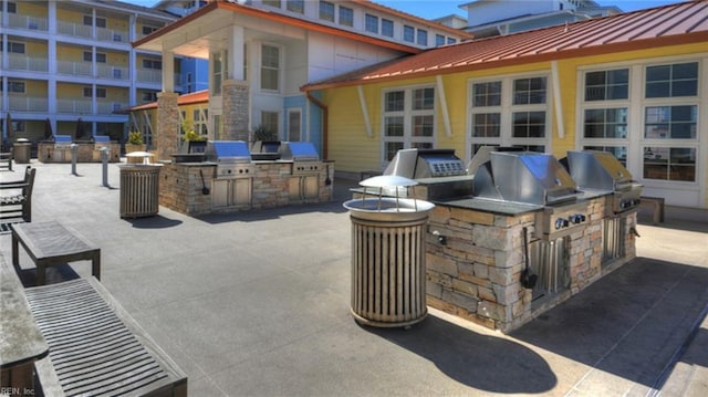 view of patio with area for grilling and a grill