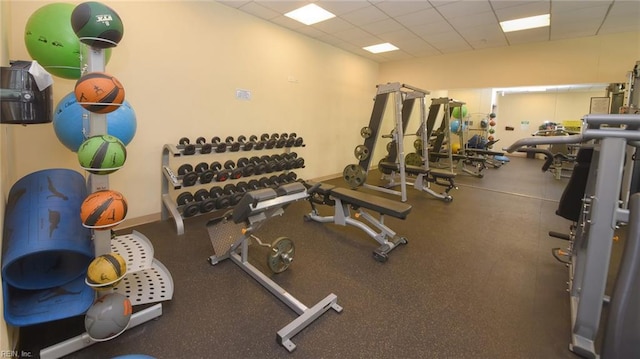 workout area with a paneled ceiling