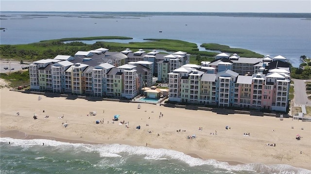 birds eye view of property with a water view and a view of the beach