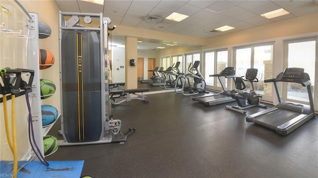 exercise room with a paneled ceiling