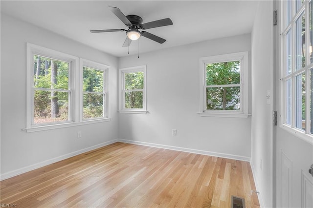 empty room with ceiling fan and light wood-type flooring