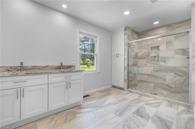 bathroom with vanity and an enclosed shower