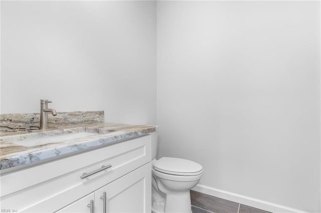 bathroom with tile patterned floors, vanity, and toilet