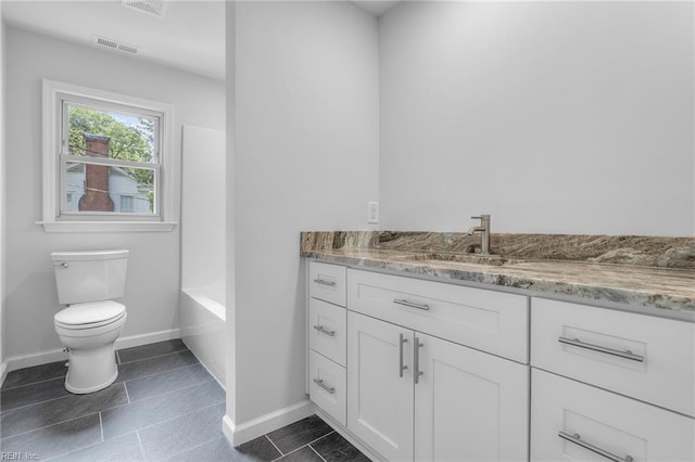 bathroom with tile patterned flooring, vanity, and toilet