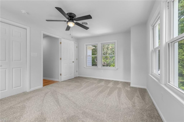 spare room featuring carpet flooring and ceiling fan